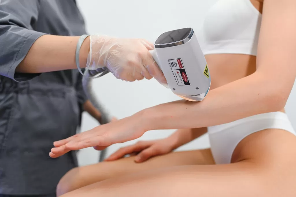 a female is receiving laser hair removal treatment session